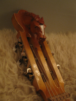 carving on doshpuluur-guitar closeup