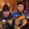Mai-ool Sedip and Ayan-ool Sam in a shop, trying out guitars. 2006 tour of USA